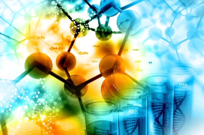 Abstract biotech concept showing molecular bonds and DNA in a series of test tubes.