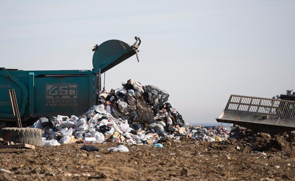 A garbage truck dumps a load of trash at Larimer County Landfill in Fort Collins, Colo. on Friday, Jan. 29, 2021.