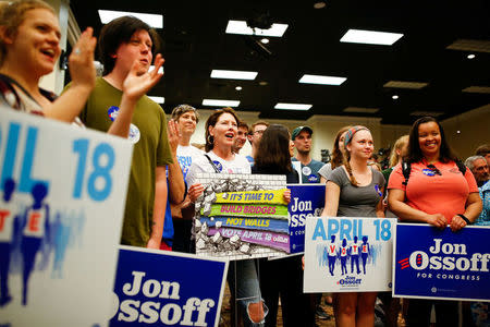 Supporters for Democratic candidate Jon Ossoff for Georgia's 6th Congressional District special election listen to him speak during an election eve rally at Andretti Indoor Karting and Games in Roswell, Georgia. REUTERS/Kevin D. Liles