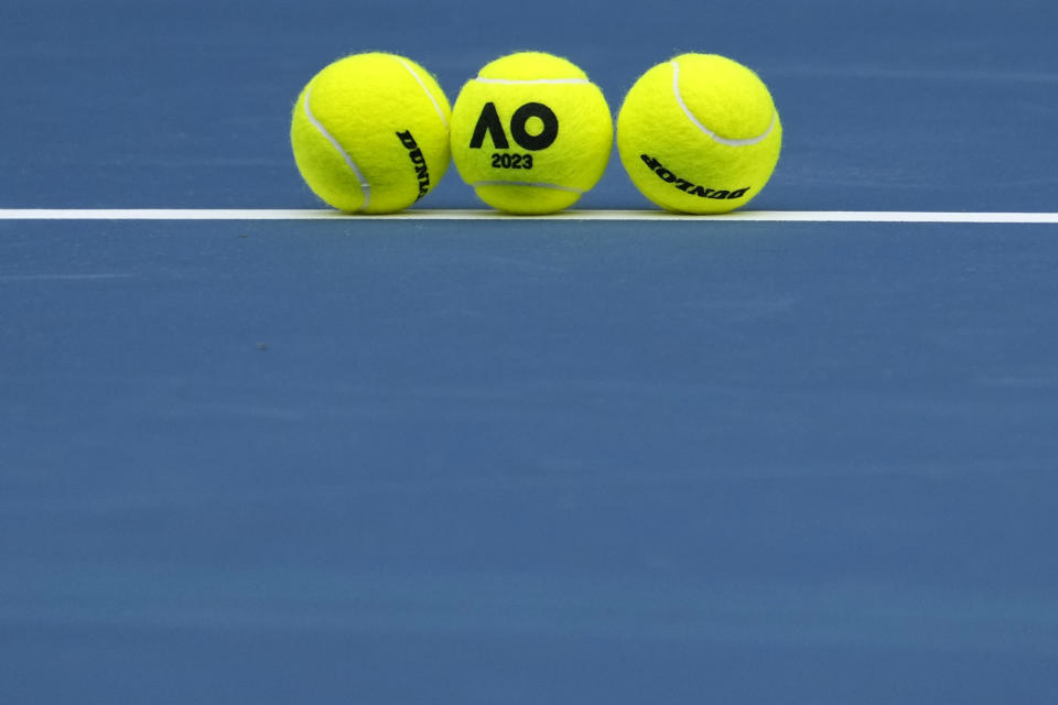 Balls placed on a court during a first round match at the Australian Open tennis championship in Melbourne, Australia, Monday, Jan. 16, 2023. (AP Photo/Ng Han Guan)