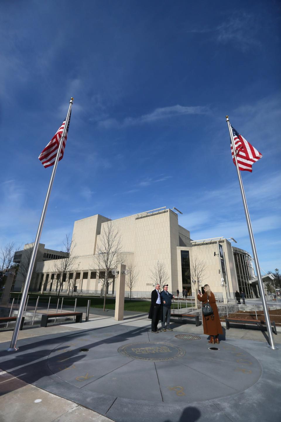 People tour the newly completed outdoor grounds where the sunken tree grove was replaced with new trees, a lawn accessible to people with disabilities and a new war memorial on Monday,  Nov. 14, 2022. A ceremony was held earlier inside to acknowledge the completion of project with local officials.