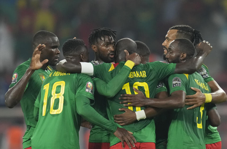 Cameroon's Karl Toko-Ekambi, center, celebrates with teammates after scoring his side's first goal during the African Cup of Nations 2022 round of 16 soccer match between Cameroon and Comoros at the Olembe stadium in Yaounde, Cameroon, Monday, Jan. 24, 2022. Cameroon beat Comoros 2-1. (AP Photo/Themba Hadebe)