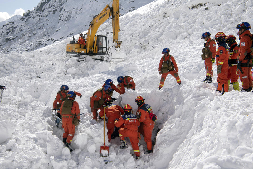 In this photo released by Xinhua News Agency, Rescuers search for survivors following an avalanche in Nyingchi, southwest China's Tibet Autonomous Region on Friday, Jan. 20, 2023. More bodies were found Friday following an avalanche that buried vehicles outside a highway tunnel in Tibet, raising the death toll more than a dozen with several people still missing. (Sun Fei/Xinhua via AP)