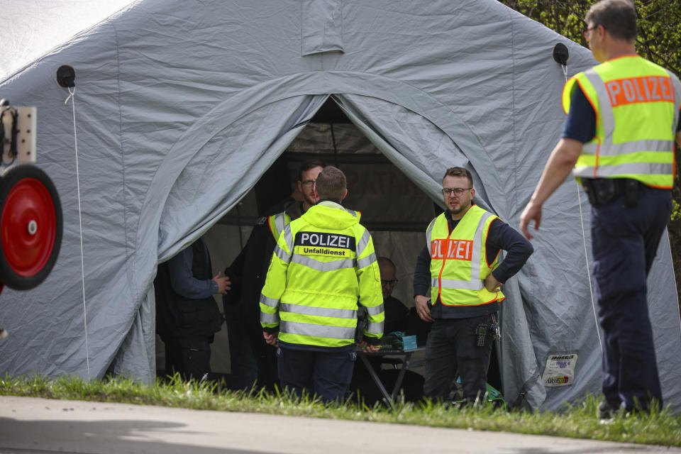 Police officers stand by a tent at the scene of the accident on the A9, near Schkeuditz, Germany, Wednesday March 27. 2024. (Jan Woitas/dpa via AP)