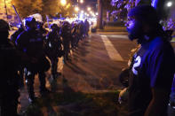 Police speak with protesters at the First Unitarian church, Thursday, Sept. 24, 2020, in Louisville, Ky. Authorities pleaded for calm while activists vowed to fight on Thursday in Kentucky's largest city, where a gunman wounded two police officers during anguished protests following the decision not to charge officers for killing Breonna Taylor. (AP Photo/John Minchillo)