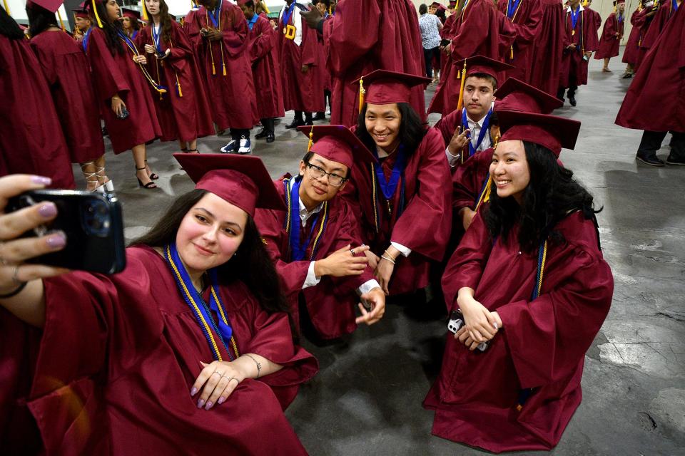 Graduates from Doherty Memorial High School capture a memory as they line up for commencement exercises at the DCU Center June 7, 2022.