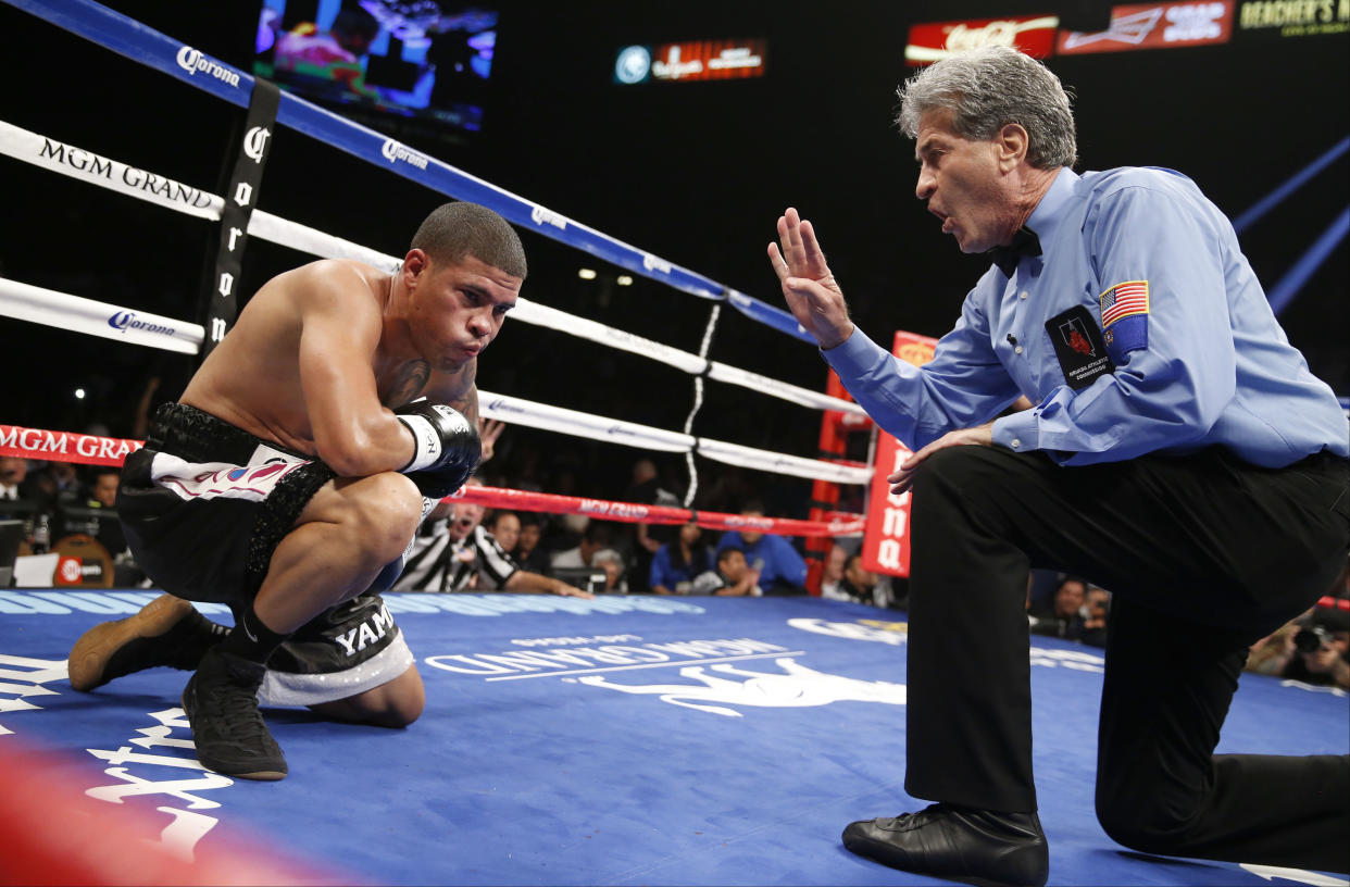 Referee Vic Drakulich counts after Juan Manuel Lopez was knocked down by Francisco Vargas during their WBO junior lightweight title fight, Saturday, July 12, 2014, in Las Vegas. (AP Photo/Eric Jamison)