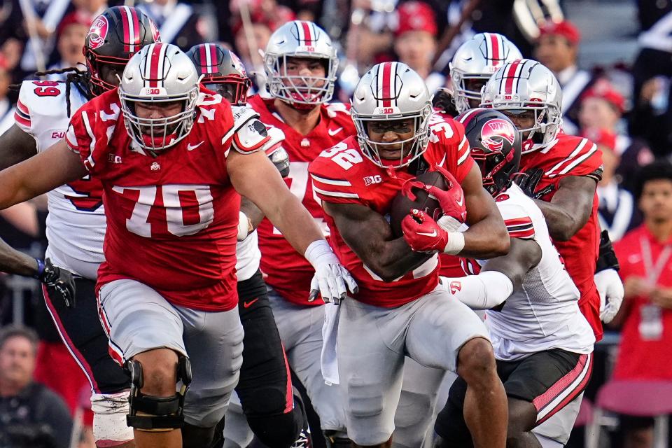 Ohio State running back TreVeyon Henderson gets a block from tackle Josh Fryar against Western Kentucky.