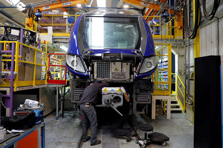 FILE PHOTO: An employee works on a new regional transport train at the Bombardier plant in Crespin, near Valenciennes, northern France, October 17, 2016. REUTERS/Benoit Tessier/File Photo