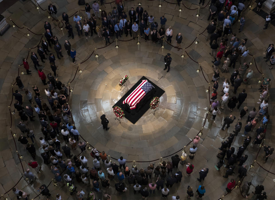 Members of the public walk past the flag-draped casket bearing the remains of John McCain of Arizona, who lived and worked in Congress over four decades, in the U.S. Capitol rotunda in Washington, Friday, Aug. 31, 2018. McCain was a six-term senator from Arizona, a former Republican nominee for president, and a Navy pilot who served in Vietnam where he endured five-and-a-half years as a prisoner of war. He died Aug. 25 from brain cancer at age 81. (AP Photo/J. Scott Applewhite)