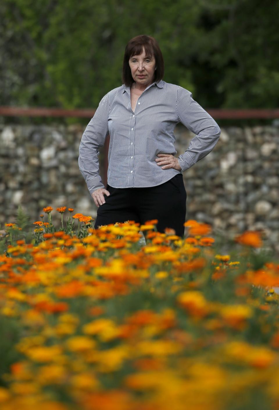 Arizona caterer Pat Christofolo, who owns Artisan by Santa Barbara Catering as well as The Farm at South Mountain, pauses at a large garden on property at The Farm has had business drop off due to the coronavirus shown here Wednesday, April 1, 2020, in Phoenix. (AP Photo/Ross D. Franklin)