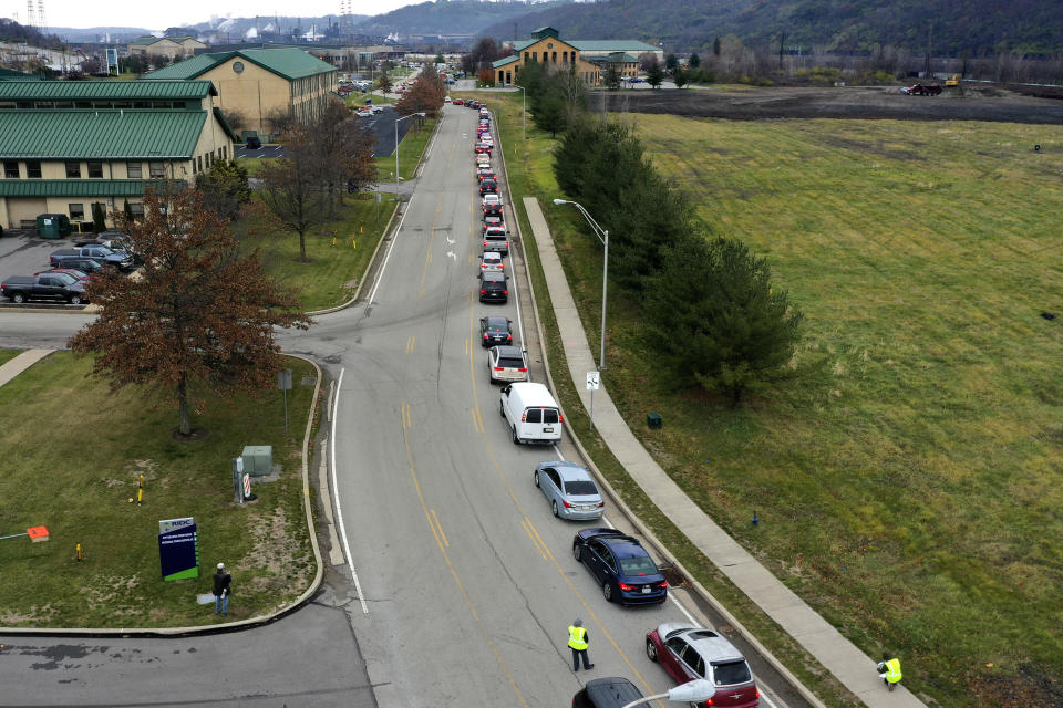 Cars wait in line during a Greater Pittsburgh Community Food bank drive-up food distribution in Duquesne, Pa., Monday, Nov. 23, 2020. While food banks have become critical during the pandemic, they’re just one path for combating hunger. For every meal from a food bank, a federal program called Supplemental Nutrition Assistance Program, or food stamps _ provides nine. (AP Photo/Gene J. Puskar)