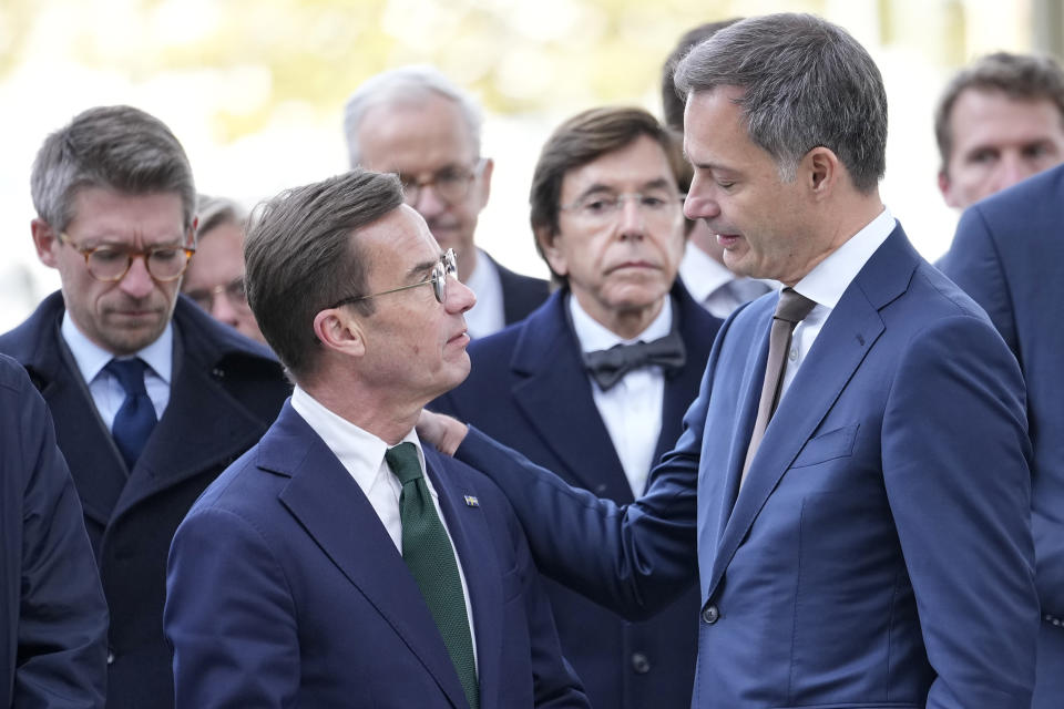 Sweden's Prime Minister Ulf Kristersson, left, speaks with Belgium's Prime Minister Alexander De Croo during a commemoration for the victims of a shooting in the center of Brussels, Wednesday, Oct. 18, 2023. Police in Belgium on Tuesday shot dead a suspected Tunisian extremist accused of killing two Swedish soccer fans in a brazen attack on a Brussels street. (AP Photo/Martin Meissner)