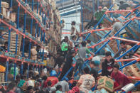 Earthquake and tsunami victims look for goods to use in a warehouse in Palu, Central Sulawesi. Antara Foto/Muhammad Adimaja/ via REUTERS