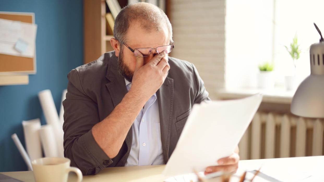 Mature Adult man working in the office.