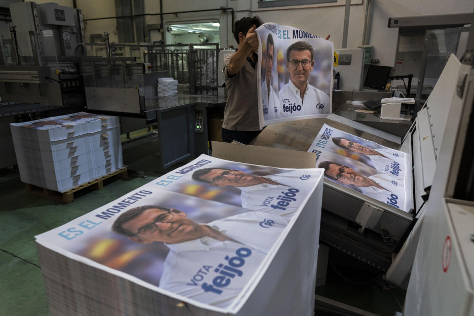 A print house staffer works on election campaign posters of Popular Party candidate Nunez Feijoo in Madrid, Spain, Friday, June 30, 2023. Spain's elections Sunday will be a battle between two leftist and two rightist parties that are teaming up to form possible coalitions. Tipped to lead his right-wing Popular Party to victory, Alberto Núñez Feijóo, 62, has had a meteoric rise in popularity since he took charge of the party in April, 2022 following an internal feud that toppled his predecessor Pablo Casado. (AP Photo/Bernat Armangue)