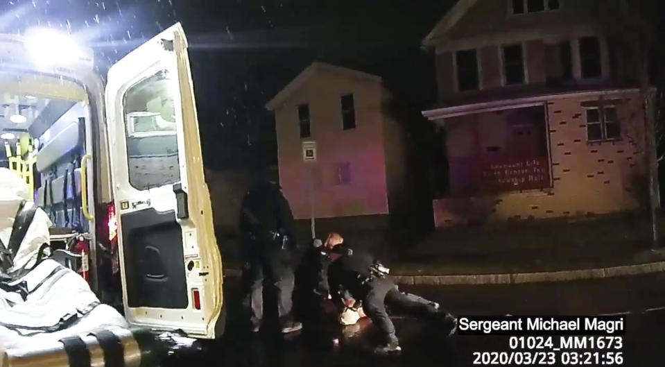 FILE - In this image taken from police body camera video provided by Roth and Roth LLP, Rochester police officers hold down Daniel Prude on March 23, 2020, in Rochester, N.Y.One of several police officers seen on video pinning down Daniel Prude, a Black man who died after being detained on a street in upstate New York, faces potential departmental discipline, the Rochester Police Department said. Officer Mark Vaughn is the only officer to be served with "departmental charges" Thursday following an internal investigation of the police response to Prude, whose death sparked nightly protests and led to the suspension of seven officers. (Rochester Police via Roth and Roth LLP via AP, File)