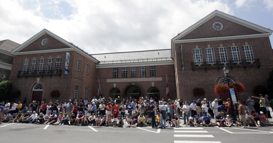 FILE - This June 16, 2008 file photo shows baseball fans in front of the National Baseball Hall of Fame and Museum in Cooperstown, N.Y. There are many destinations of interest to baseball fans around the country outside ballparks from museums and statues to historic homes. (AP Photo/Mike Groll, File)