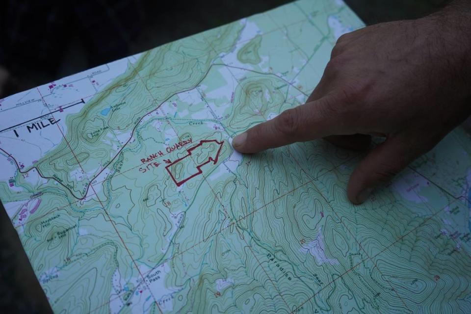 Andrew Clarke, one of the neighbors opposed to the Ranch Quarry Mine proposed off South Pass Road, points to a map on Sept. 1, 2023, of the project site, which borders his property in Whatcom County, Wash.