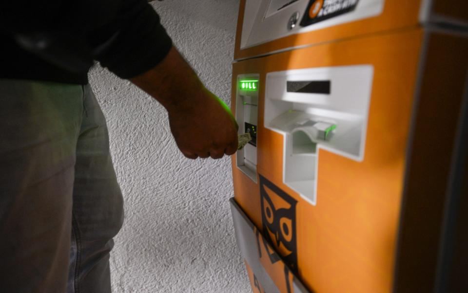 A man withdraws cash from a bitcoin ATM in El Zonte, El Salvador - Alex Pena/Anadolu Agency