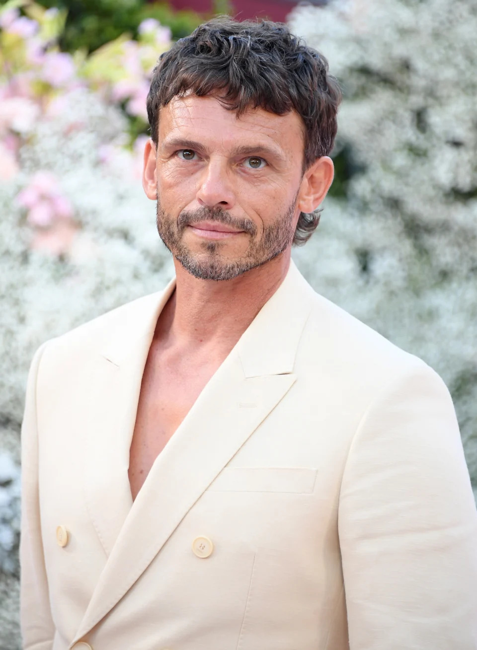 Arnaud Binard in a cream suit at the premiere for "Emily in Paris"