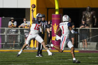 Arizona quarterback Will Plummer (15) throws off balance to wide receiver Stanley Berryhill III (1) against Arizona State in the first half during an NCAA college football game, Saturday, Nov. 27, 2021, in Tempe, Ariz. (AP Photo/Rick Scuteri)