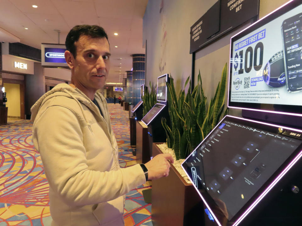 Matt Smircich of Hamburg, N.J. makes sports bets at the Hard Rock casino in Atlantic City, N.J. on Feb. 2, 2024. On Feb. 6, 2024, the American Gaming Association estimated that a record 68 million Americans would wager a total of $23.1 billion on this year's Super Bowl, legally or otherwise. (AP Photo/Wayne Parry)