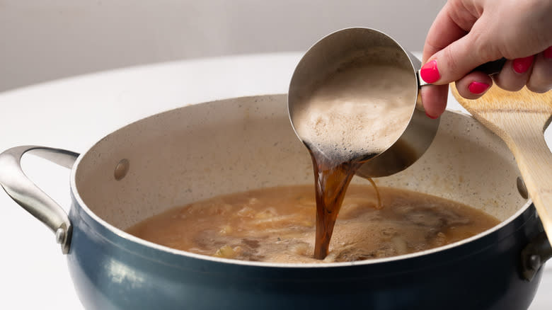 pouring Guinness into pan