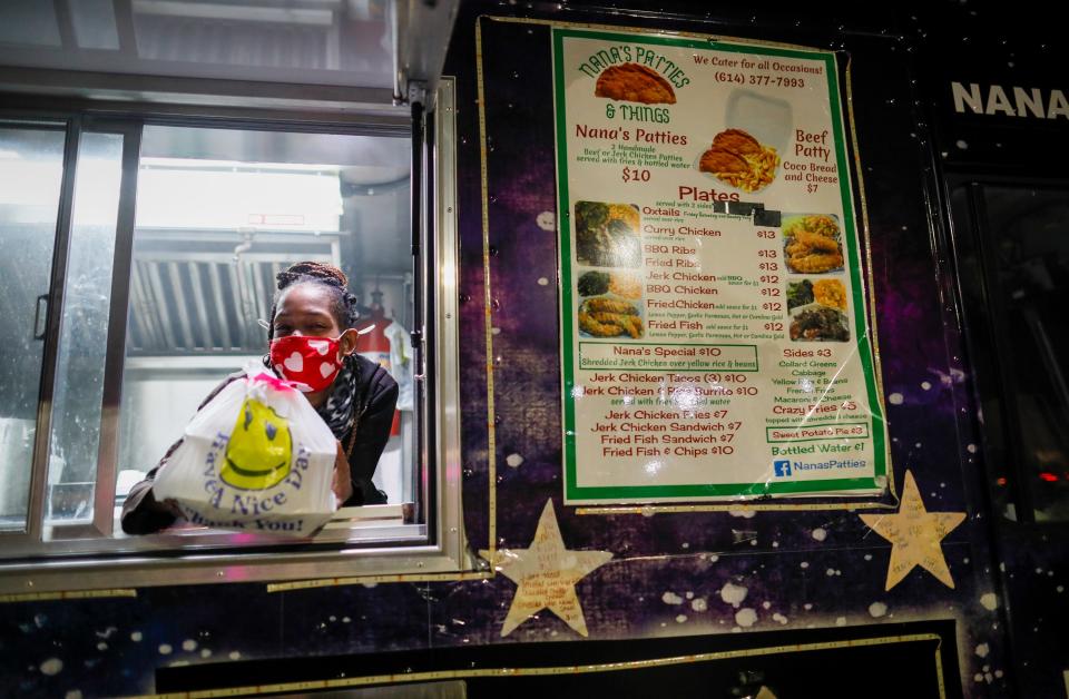 Shay Maley wraps up an order for Nana's Patties & Things, a food truck that uses the delivery service Trap Eats. Nana's owner Quiyonna Johnson said she hopes more people use the service.