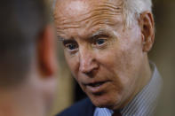 Democratic presidential candidate former Vice President Joe Biden speaks with an audience member during a community event, Wednesday, Oct. 16, 2019, in Davenport, Iowa. (AP Photo/Charlie Neibergall)