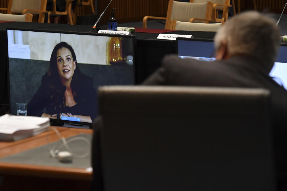 Mel Silva, left, the managing director of Google Australia and New Zealand, appears via a video link during a Senate inquiry into a mandatory code of conduct proposed by the government at Parliament House in Canberra, Friday, Jan. 22, 2021. Google on Friday threatened to make its search engine unavailable in Australia if the government went ahead with plans to make tech giants pay for news content. (Mick Tsikas/AAP Image via AP)