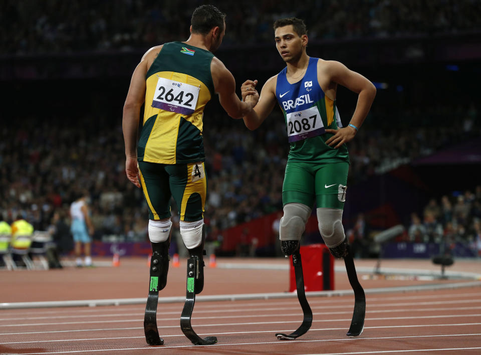 Brazil's Oliveira is congratulated by South Africa's Pistorius after winning the men's 200m T44 classification at the Olympic Stadium during the London 2012 Paralympic Games