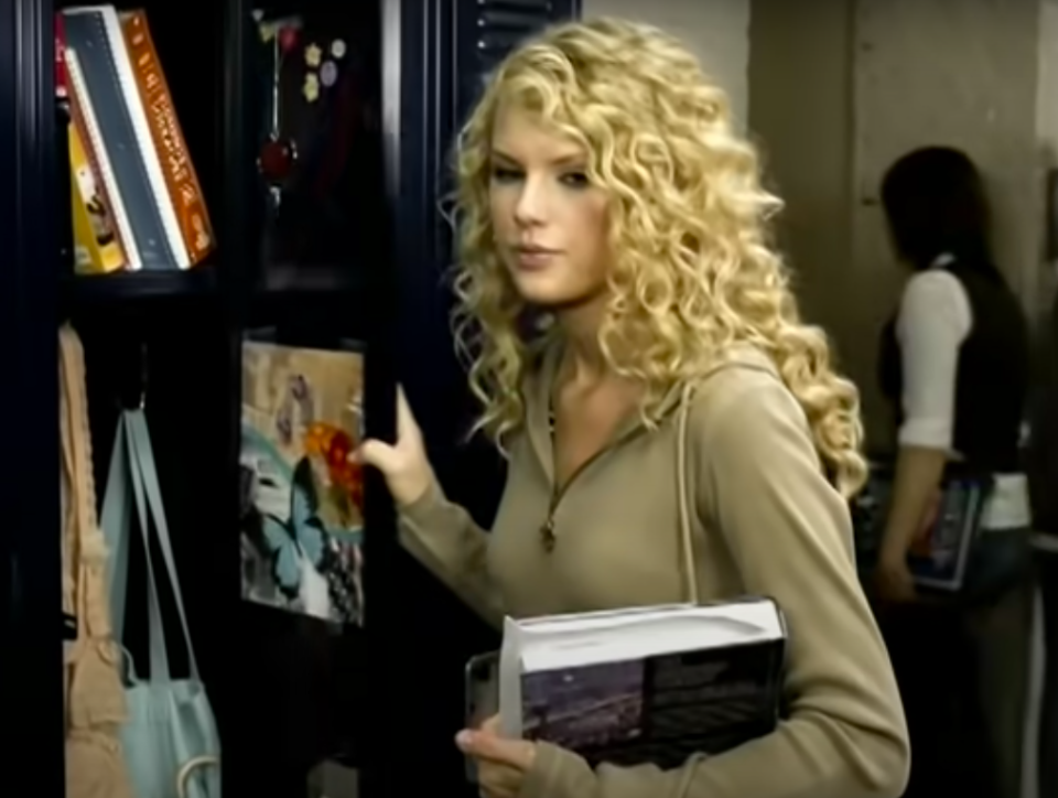 taylor grabbing books from a locker