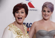 Sharon Osbourne and her daughter Kelly Osbourne pose as they arrive at the 20th annual Race to Erase MS benefit gala in Los Angeles, California May 3, 2013. The event raises money to fund research to find a cure for multiple sclerosis. REUTERS/Fred Prouser (UNITED STATES - Tags: ENTERTAINMENT HEALTH)
