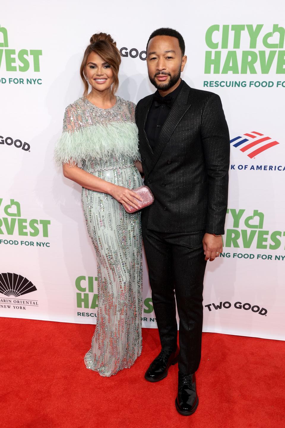 Chrissy Teigen and John Legend attend a City Harvest fundraiser in New York on April 26, 2022, to help provide meals for those in need.