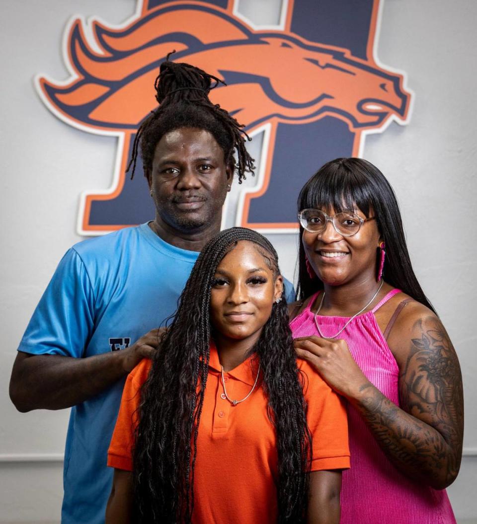 Homestead, Florida, August 28, 2023 - Janiya Baker, center, with her mother Jasmine Gary, right, and her stepfather Travis Terry Sr., left, at Homestead High School.