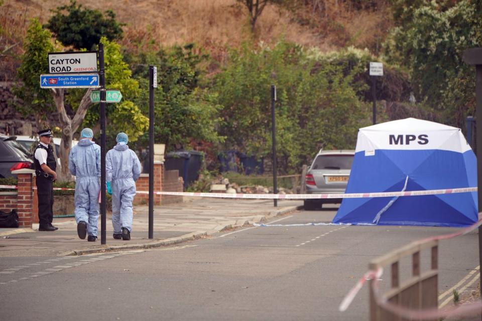 Police and forensic officers at the scene near to Cayton Road, Greenford (PA) (PA Wire)