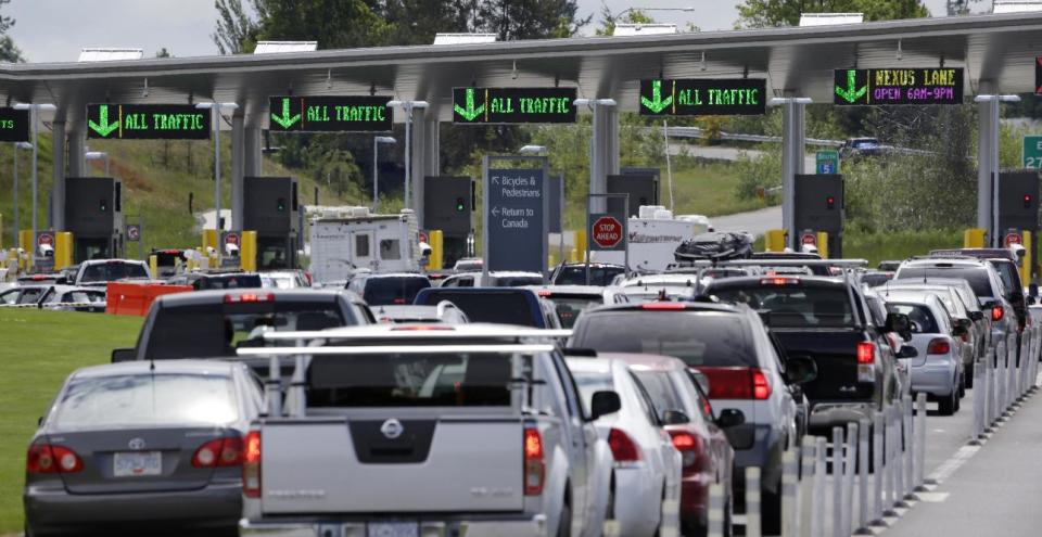 In this Thursday, May 23, 2013 photo, cars from Canada line up to cross into the U.S. in Blaine, Wash. In April 2013, in its 2014 fiscal year budget proposal, the Department of Homeland Security requested permission to study a fee at the nation's land border crossings. The request has sparked wide opposition among members of Congress from northern states, who vowed to stop it. A fee, they say, would hurt communities on the border that rely on people, goods and money moving between the U.S. and Canada. (AP Photo/Elaine Thompson)