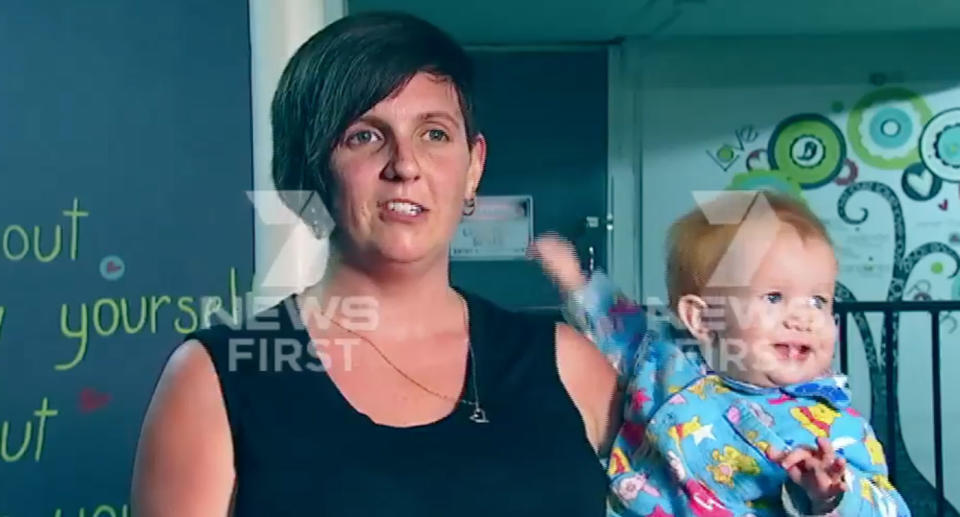 Angela Stevenson, from Gladstone, and her 12-month-old daughter after finding the needle inside the Woolworths strawberries. Source: 7 News