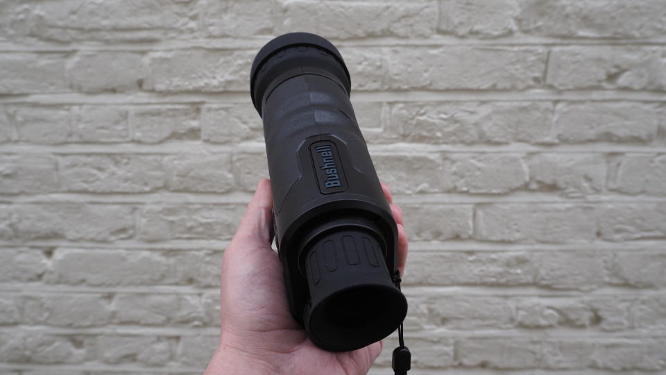 Bushnell Equinox Z2 6x50 Night Vision Monocular held in a hand against a white wall