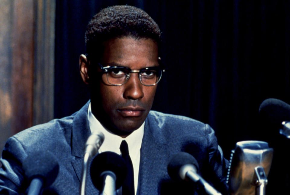 Denzel Washington as Malcolm X talking at a press conference