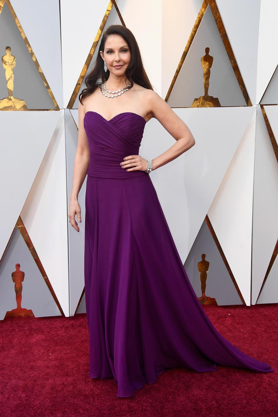 <p>Ashley Judd brought some serious colour to the Oscars wearing a bright purple strapless number which was a custom Badgley Mischka dress, paired with diamond drop earrings and diamond statement necklace designed by Bulgari.</p>