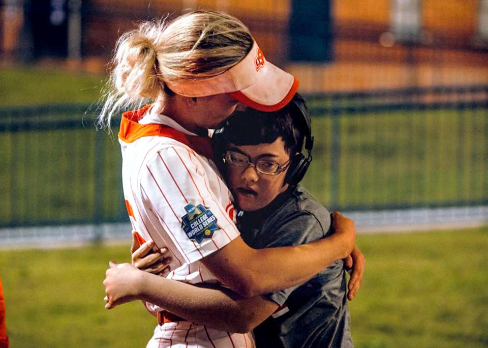 OSU outfielder Chelsea Alexander hugs her younger brother, Caden, after a WCWS game last year.