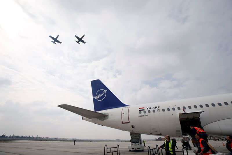 Syrian jets fly in the sky in celebration at Aleppo International airport