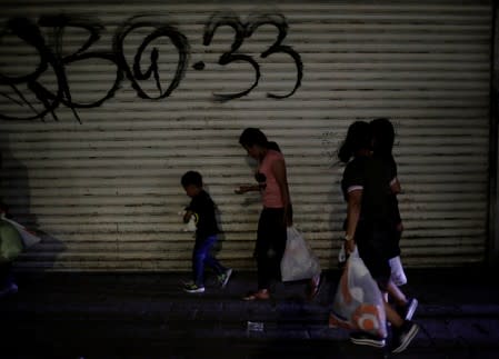 Central American migrants walk along the street after their return to Mexico from the U.S. under the Migrant Protection Protocol (MPP) to wait for their court hearing for asylum seeking, in Ciudad Juarez