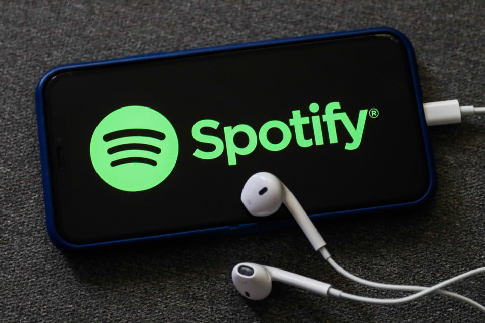 Spotify logo displayed on a phone screen and headphones are seen in this illustration photo taken in Poland on October 18, 2020.   (Photo Illustration by Jakub Porzycki/NurPhoto via Getty Images)