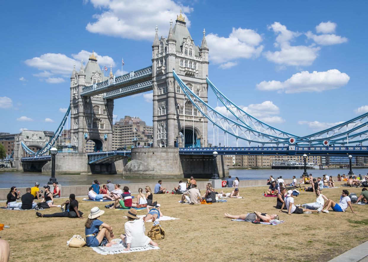 People enjoy the Bank Holiday Monday warm weather in front of Tower Bridge, in Potters Field Park,  London, as people head outside with lockdown measures eased. Picture date: Monday 25th May 2020. Photo credit should read: David Jensen/EMPICS Entertainment