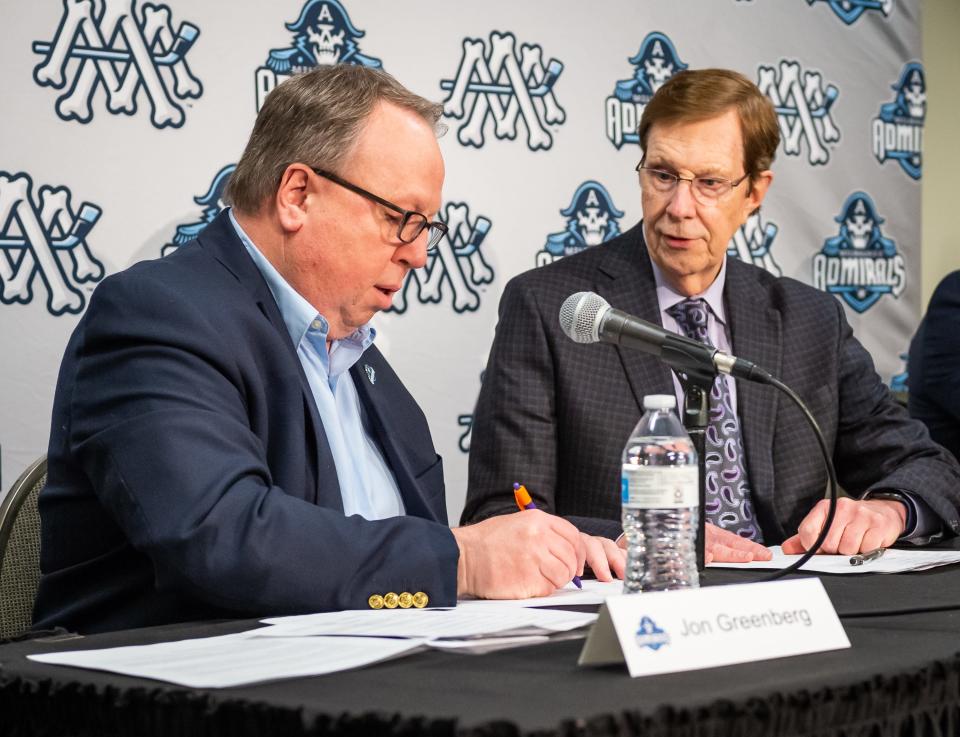 Milwaukee Admirals President Jon Greenberg and Nashville Predators general manager David Poile sign an affiliation extension agreement Wednesday at the UW-Milwaukee Panther Arena.