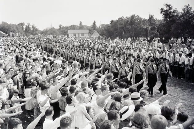 Hundreds of German Americans give the Nazi salute to young men marching in Nazi uniforms at Camp Sigfried on Long Island, NY. - Credit: Getty