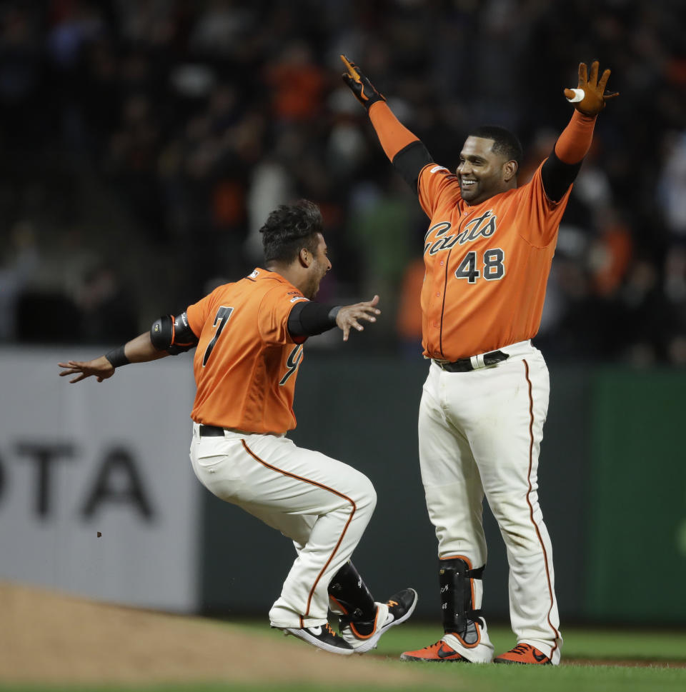 San Francisco Giants' Pablo Sandoval, right, celebrates with Donovan Solano (7) after the team's baseball game against the New York Mets on Friday, July 19, 2019, in San Francisco. The Giants won 1-0 in 10 innings. (AP Photo/Ben Margot)